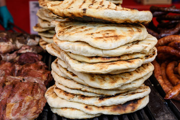 Stack of home made pita bread for sale at a fast food restaurant at a street food market
