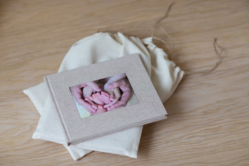 The photo book is on the wooden floor