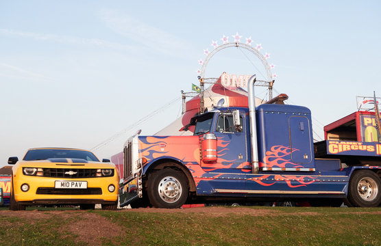 cleveleys, england, 05/05/2019 A yellow chevrolet and industrial american monster truck designed as optimus prime from the transformers movie. transformer vehicles outside a circus.