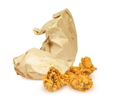 Fried Breaded Chicken Fillet In A Paper Bag Brown Isolated On A White Background.