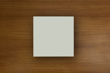 White empty paper square in dark background for mockup purposes