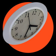 Wall clock on a black background with a bright orange circle