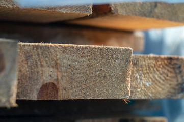 Wooden board in a pile of other boards with blur
