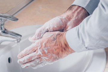 Fototapeta premium Washing hands rubbing with soap man for corona virus prevention, hygiene to stop spreading coronavirus.