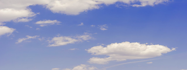white fluffy clouds on blue sky in summer
