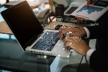 Businessman working as a team start meeting the new marketing project plan By business people using tablets and graph documents Calculate the amount of money for the project.