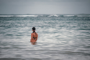 Beach views of the cliffs, splashing waves and traditional fishing boats on the shore.