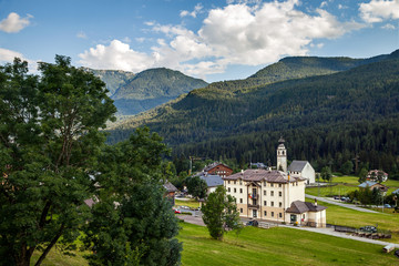 Fototapeta premium Alpine village with town hall and Church in summer