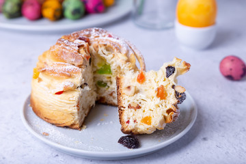 Craffin (Cruffin) with raisins, nuts and candied fruits. Easter Bread Kulich and painted eggs. Easter Holiday. Close-up.