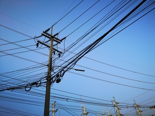 Electric poles with wires and blue sky
