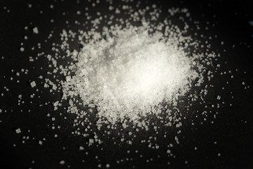 Pile of  white sea salt on black background