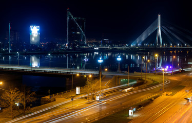 Fototapeta na wymiar Modern bridge and buildings in Riga at night