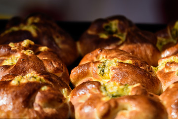 Traditional Romanian sweets knows as poale in brau, freshly homemade cheese and dill buns on display for sale at a street food market, top view of healthy food photographed with selective focus
