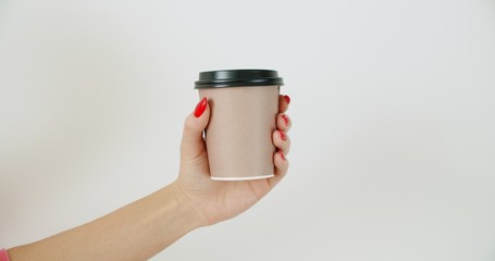 Mockup of female hand holding coffee paper cup