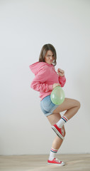 Young woman blowing balloon
