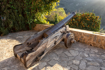 Ancient weapons. war cannon. Large wooden wheels