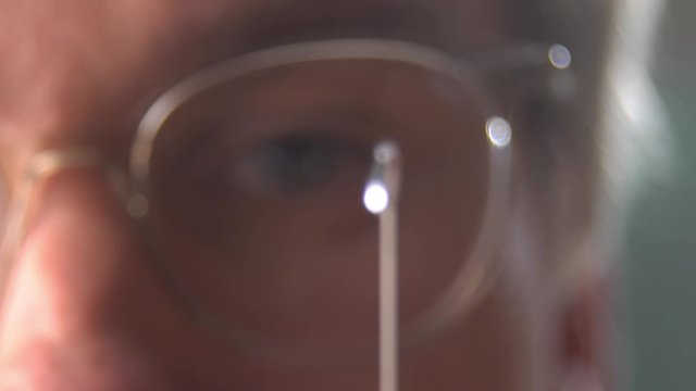 A doctor or scientist in laboratory holding a syringe with liquid vaccines for children or older adults, or cure animal diseases. Concept:diseases,medical care,science, anesthesia,euthanasia,diabetes.
