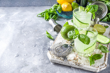 Cucumber basil smash gin and vodka alcohol cocktail. Infused summer mocktail with fresh basil...