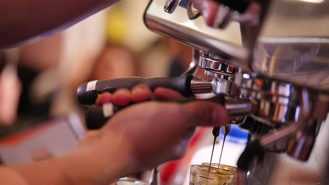 Barista Put the coffee stalk into the coffee machine to make coffee, taken with a specific focus technique.