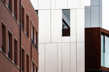 Different types of modern building facades made of steel sheets or dutch clinker