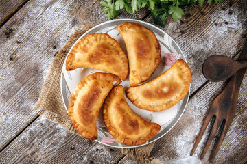 Central Asian cuisine cheburek deep fried meat patties made from unleavened dough, top view, horizontal
