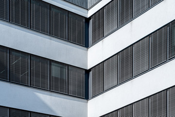 Modern facade front of modern business office building with dark window shades and white walls