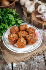Side view on appetizing cooked homemade meatballs with meat, rice and vegetables, tefteli, with mashed potatoe, red sauce and garlic, vertical
