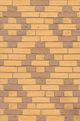 Texture of beige and brown dutch brick facade with diamond pattern
