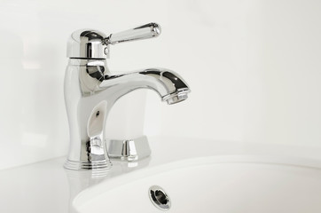 New stainless steel faucet. Modern bathroom interior.