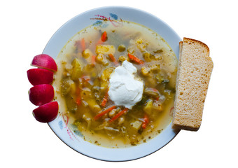 Vegetable soup with sour cream and fresh radishes, bread.