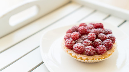 cupcake with fresh raspberries and powdered sugar close up 