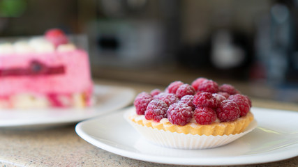 cupcake with fresh raspberries and powdered sugar close up 