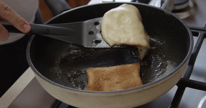 Cooking Toast Bread with Ham and Cheese on a Frying Pan at Home Kitchen Shot on Red Camera
