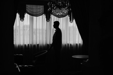 silhouette of the groom at the window