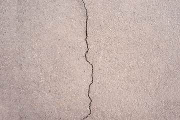 Asphalt divided into two parts by a crack. destruction, dilapidation.