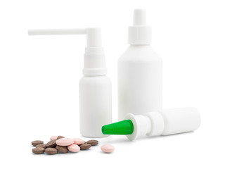 Different sprays and vials of white color and a handful of tablets on a white background, mock up. Layout for branding, advertising, presentation, and design. Medical sprays and antiseptics