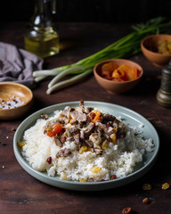 Pilaf with spices and dried fruits on a plate.