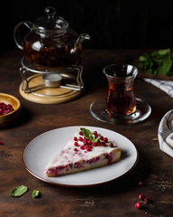 Lingonberry pie with tea on a wooden table.