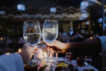 Two glasses raised in a toast close-up.
