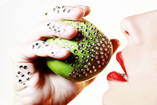 apple detail with glossy decoration and red woman's lips 
