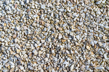 Background made of small white and brown pebbles, top view.
