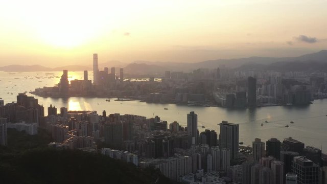 Aerial View Sunrise of the Hong Kong City Skyline and sunflares 4K stock video. 