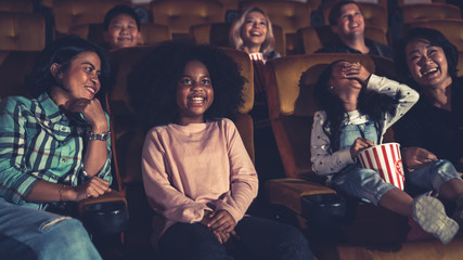 People audience watching movie in the movie theater cinema. Group recreation activity and...