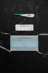Personal protection against new coronavirus on dark, distressed background