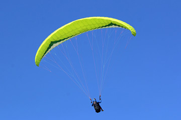 Paraglider flying wing in a blue sky	