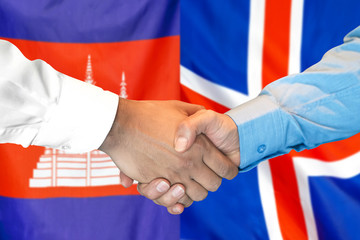 Handshake on Cambodia and Iceland flag background. Support concept.