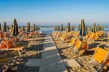 Rows of orange umbrellas and deckchairs