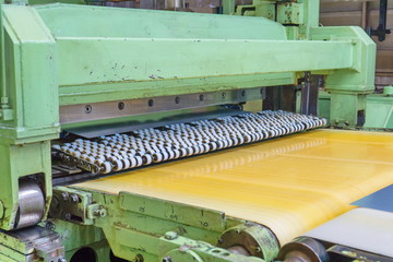 Rotary shear machine cutting steel sheet, metal transmutation processing. Steel service center...