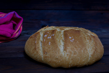 bread fresh from the oven on a dark wooden table