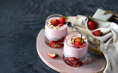 Chia seeds pudding with strawberry and banana in glasses, healthy tasty dessert. Copy space,...